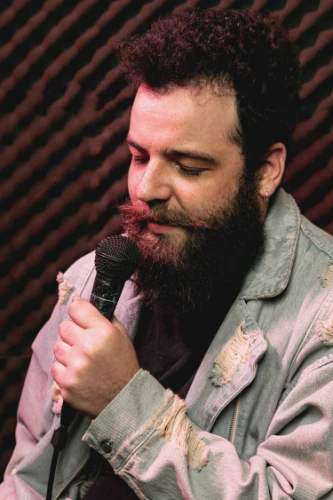 stylish-beard-man-singing-microphone