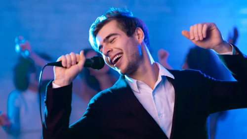 young-man-singing-song-having-fun-partying-at-nigh-2025-03-18-15-57-08-utc