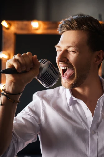young-man-with-microphone-is-singing-at-home-2024-10-16-12-28-19-utc